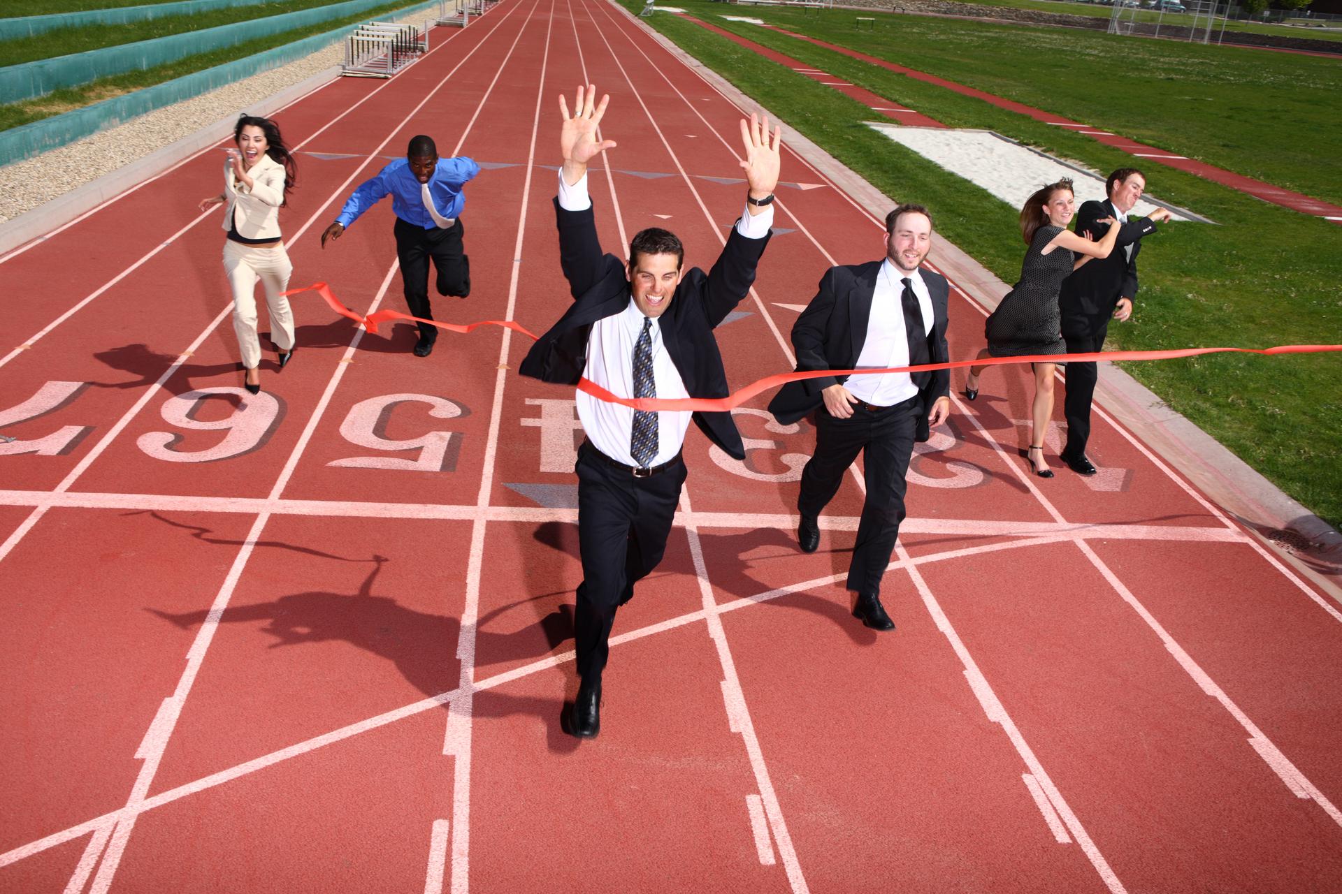 Business people crossing finish line